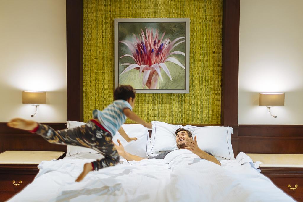 Occidental at Xcaret Destination - All Inclusive Xcaret Park Esterno foto A child jumps on a bed.
